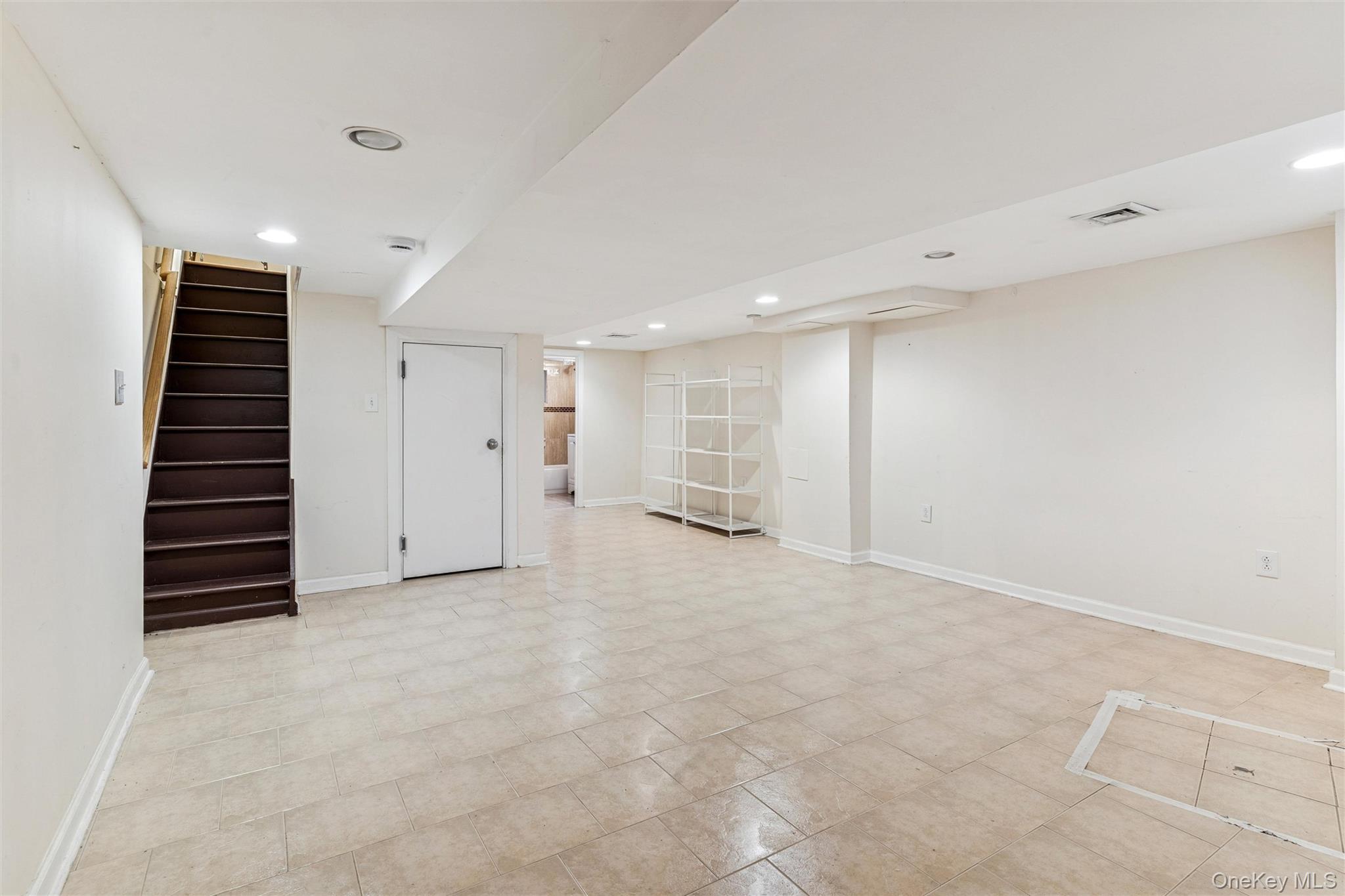 91-25 90th Street Queens, NY 11421 - Photo 24 of 30 Finished below grade area featuring recessed lighting and stairs