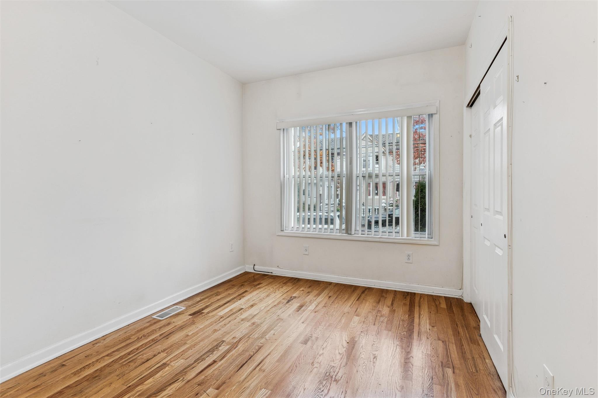 91-25 90th Street Queens, NY 11421 - Photo 5 of 30 Unfurnished bedroom featuring light wood-type flooring and a closet