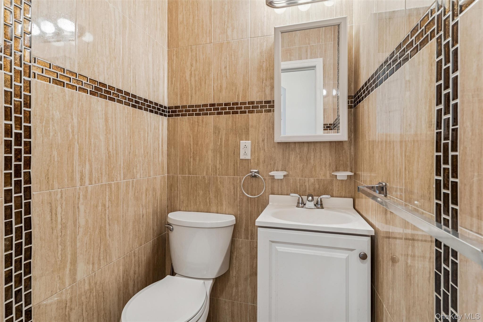 91-25 90th Street Queens, NY 11421 - Photo 7 of 30 Half bathroom with vanity and tile walls