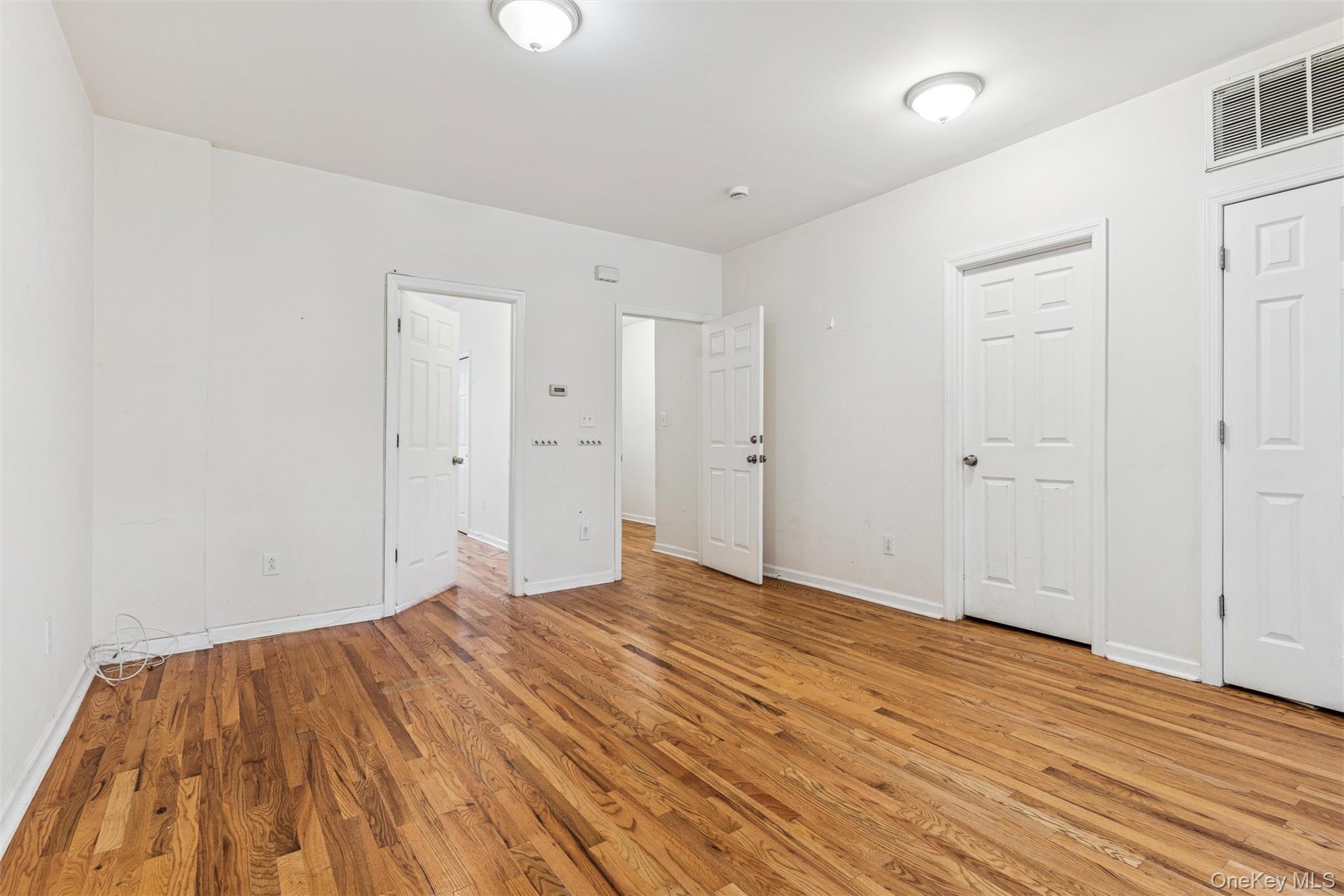91-25 90th Street Queens, NY 11421 - Photo 9 of 30 Unfurnished bedroom with light wood-type flooring and baseboards