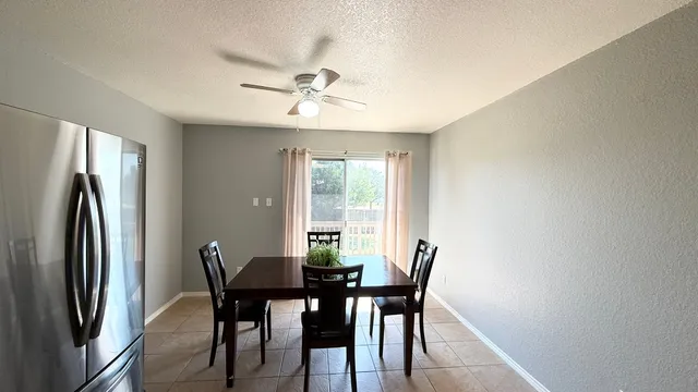 a view of a dining room with furniture and window