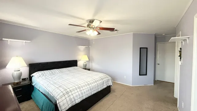 a bedroom with a bed and a chandelier