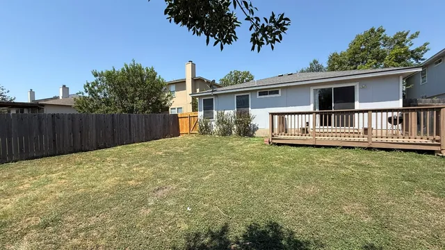 a backyard of a house with table and chairs