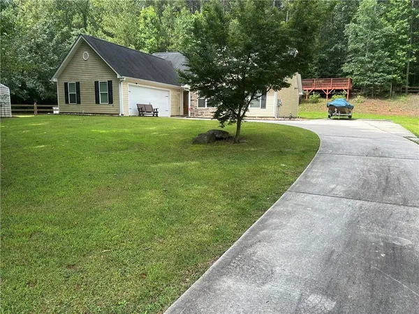 a view of backyard of house with green space