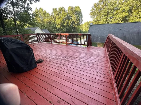 a view of deck with table and chairs and wooden floor