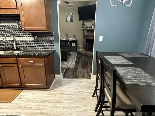 a kitchen with a sink cabinets and wooden floor