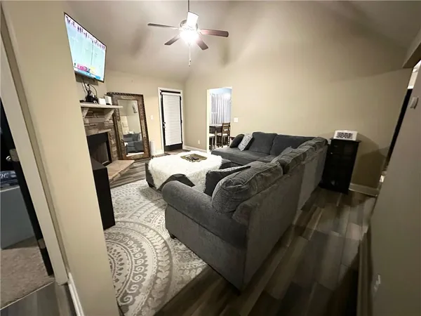 a living room with furniture and a flat screen tv