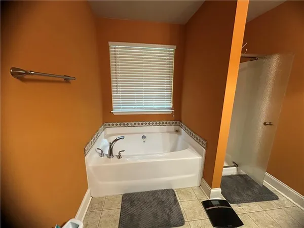a bathroom with a bathtub and a shower