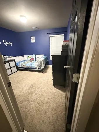 a bedroom with a bed and a mirror