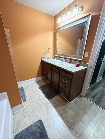 a view of bathroom with a sink and mirror