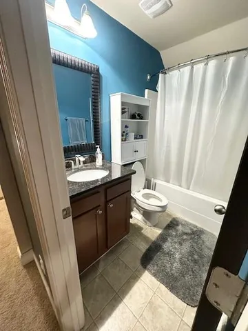 a view of walk in closet with clothes