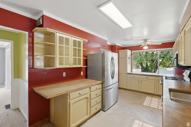 378 West 200 South Bountiful, UT 84010 - Photo 13 of 32 Kitchen featuring a large window, light-colored cabinetry with glass inserts, wood-finish countertops, and a stainless steel refrigerator