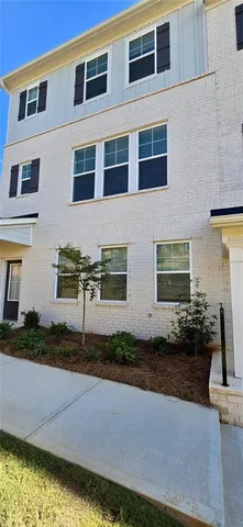 a front view of a house with a yard and a garage