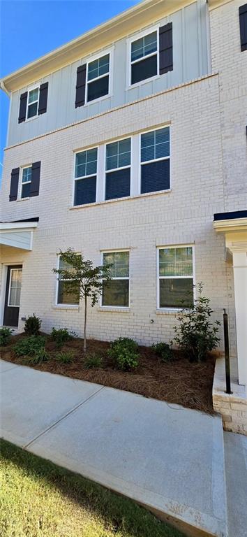 a front view of a house with a yard and a garage
