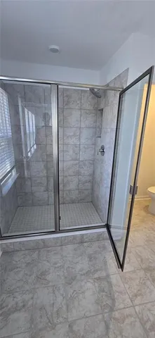 a bathroom with a glass shower door