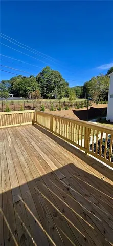 a view of a balcony with wooden floor