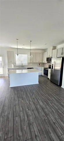 a view of kitchen and wooden floor