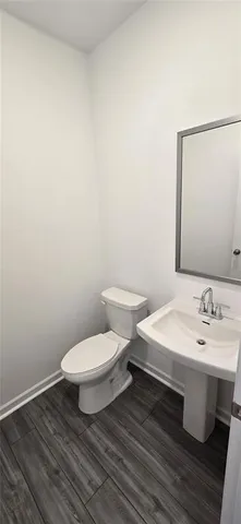 a white toilet sitting next to a bathroom sink