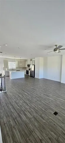 a view of a room with wooden floor