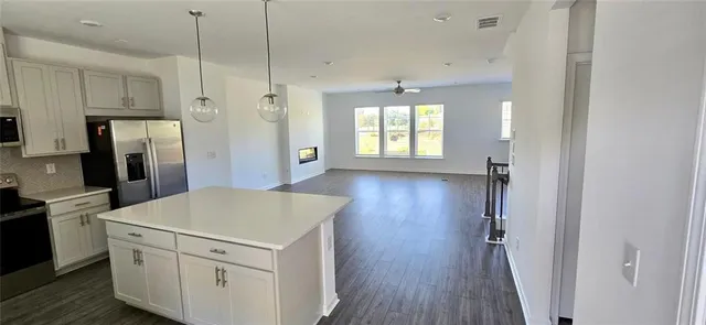 a kitchen with a refrigerator a sink and dishwasher a oven with wooden floors