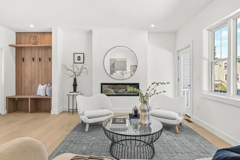 a living room with furniture a table and a potted plant