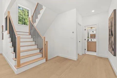a view of entryway with wooden floor and stairs