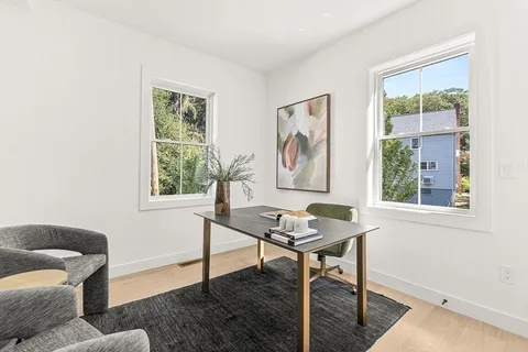 a living room with furniture a window and a table