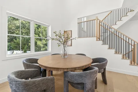 a dining room with furniture and wooden floor