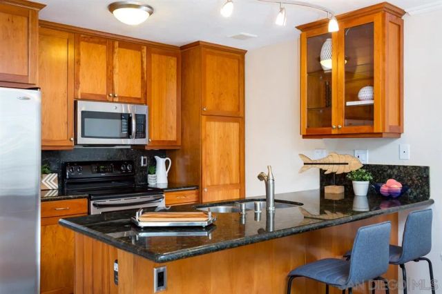 a kitchen with a sink stove and microwave