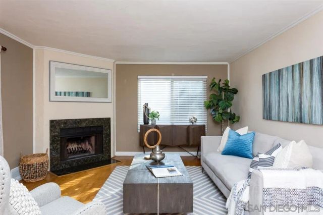 a living room with furniture and a fireplace