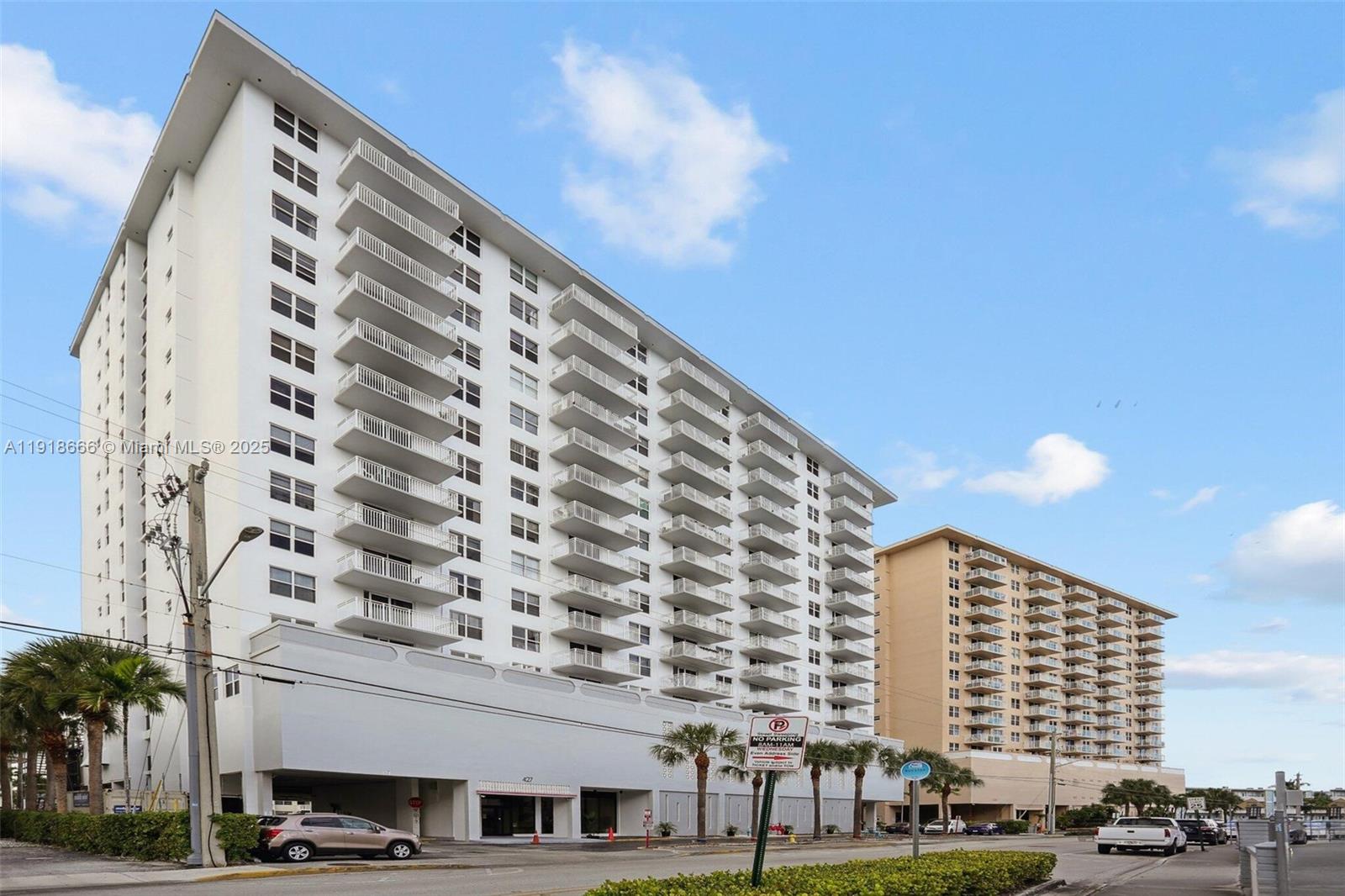 427 Golden Isles Drive, Unit 11F Hallandale Beach, FL 33009 - Photo 1 of 24 a view of a building with a street