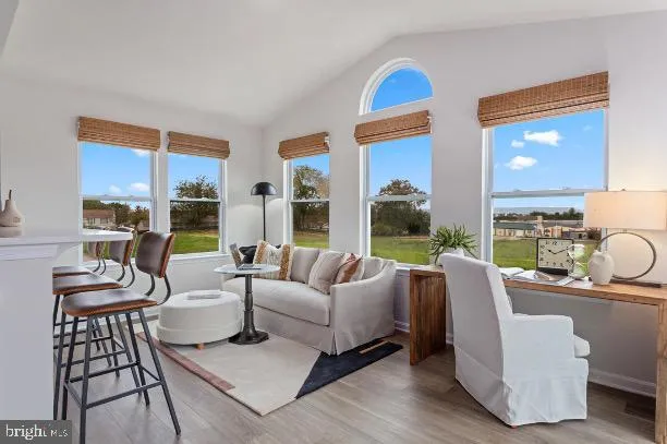 a living room with furniture fireplace and a large window