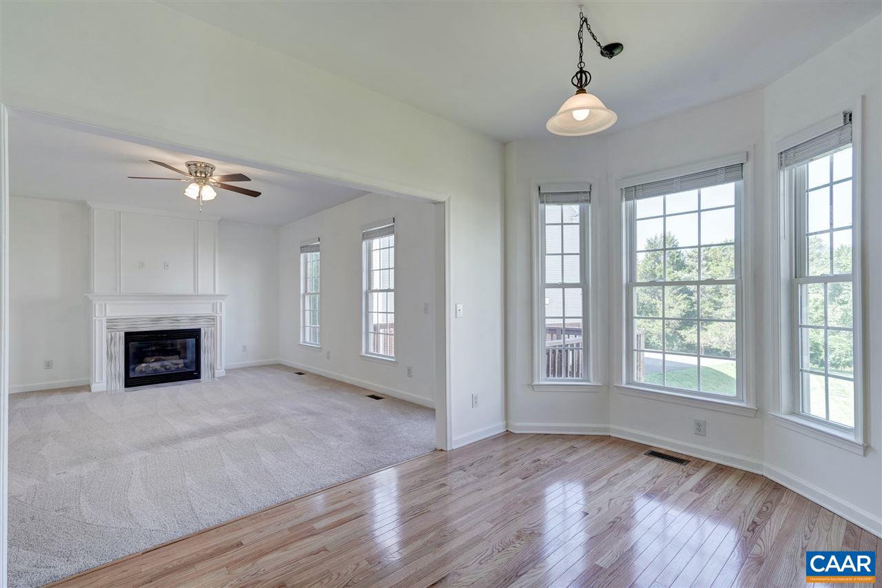 1280 Amber Ridge Road Charlottesville, VA 22901 - Photo 13 of 33 a view of an empty room with a fireplace and a window