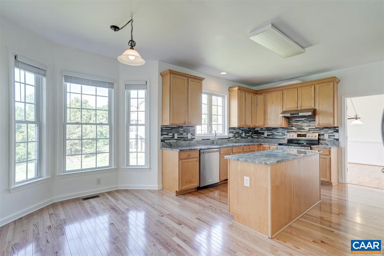 1280 Amber Ridge Road Charlottesville, VA 22901 - Photo 14 of 33 a open kitchen with granite countertop a stove top oven a sink dishwasher a dining table and chairs with wooden floor
