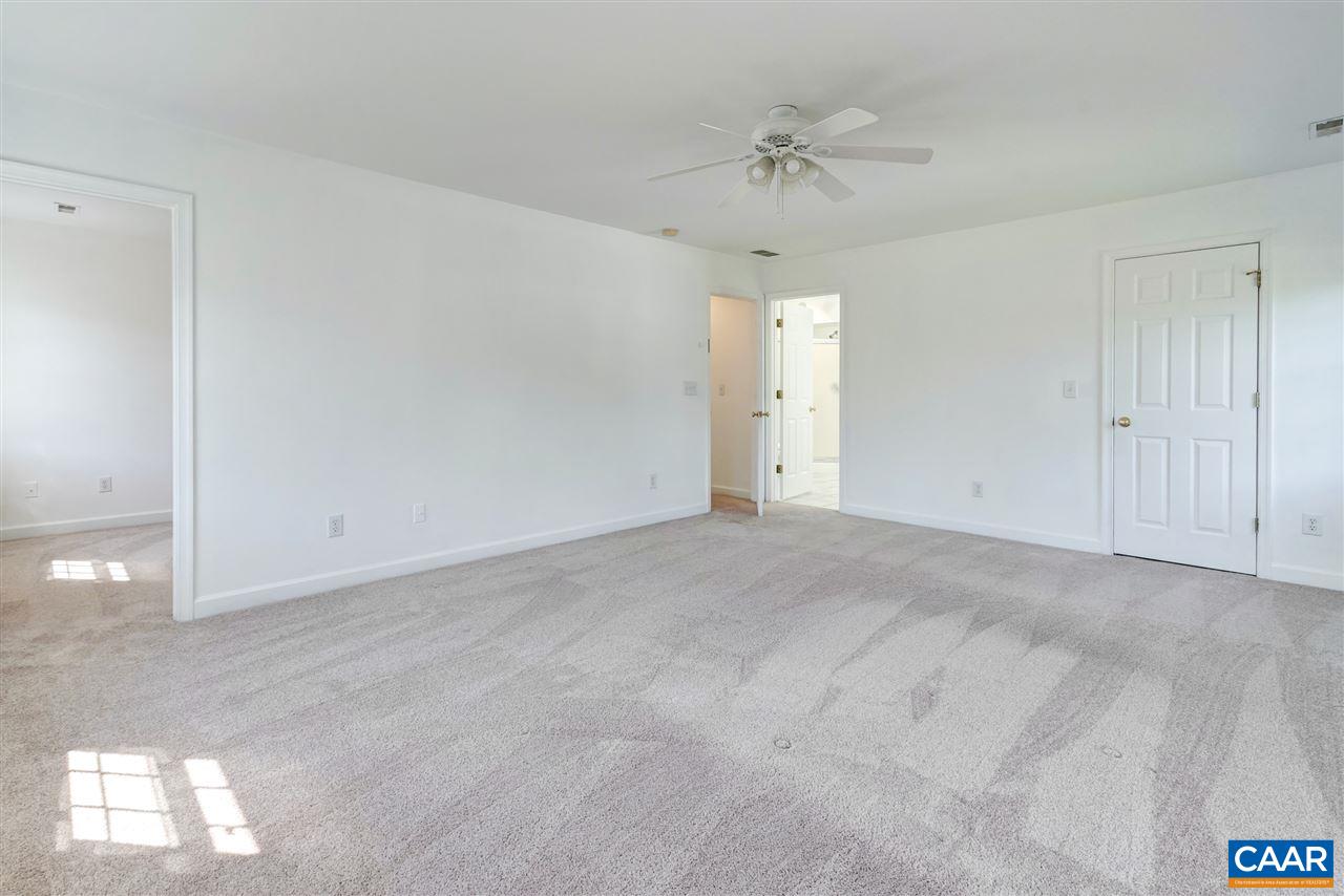 1280 Amber Ridge Road Charlottesville, VA 22901 - Photo 19 of 33 a view of an empty room with a chandelier fan