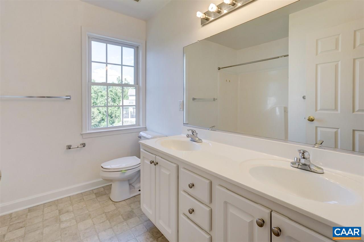 1280 Amber Ridge Road Charlottesville, VA 22901 - Photo 26 of 33 a bathroom with a toilet a sink a mirror and a window