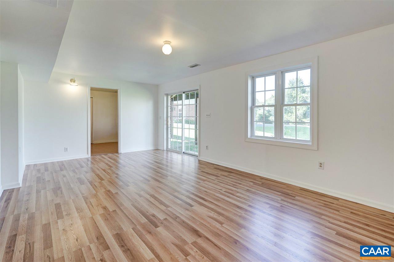 1280 Amber Ridge Road Charlottesville, VA 22901 - Photo 28 of 33 a view of an empty room with wooden floor and a window