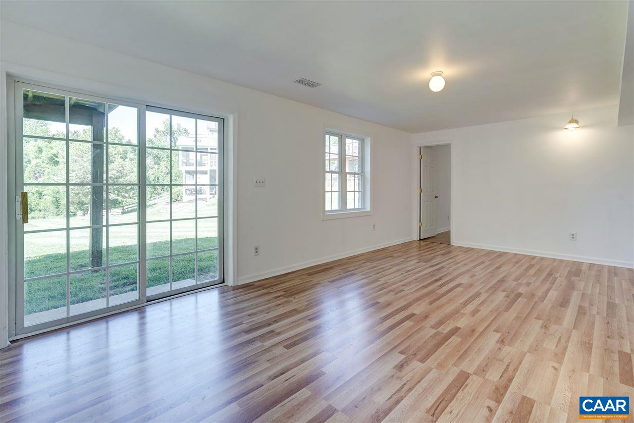 1280 Amber Ridge Road Charlottesville, VA 22901 - Photo 29 of 33 an empty room with wooden floor and windows