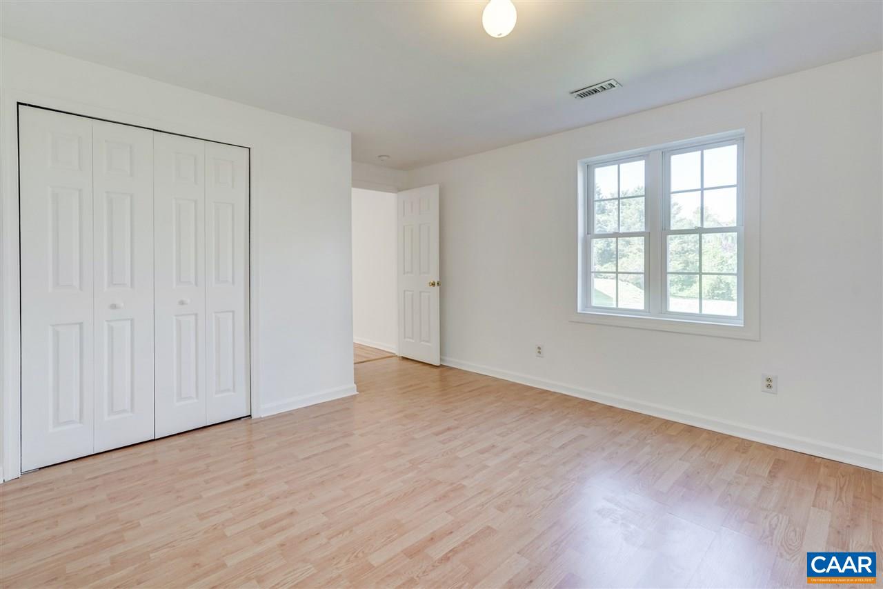 1280 Amber Ridge Road Charlottesville, VA 22901 - Photo 30 of 33 a view of an empty room with wooden floor and a window