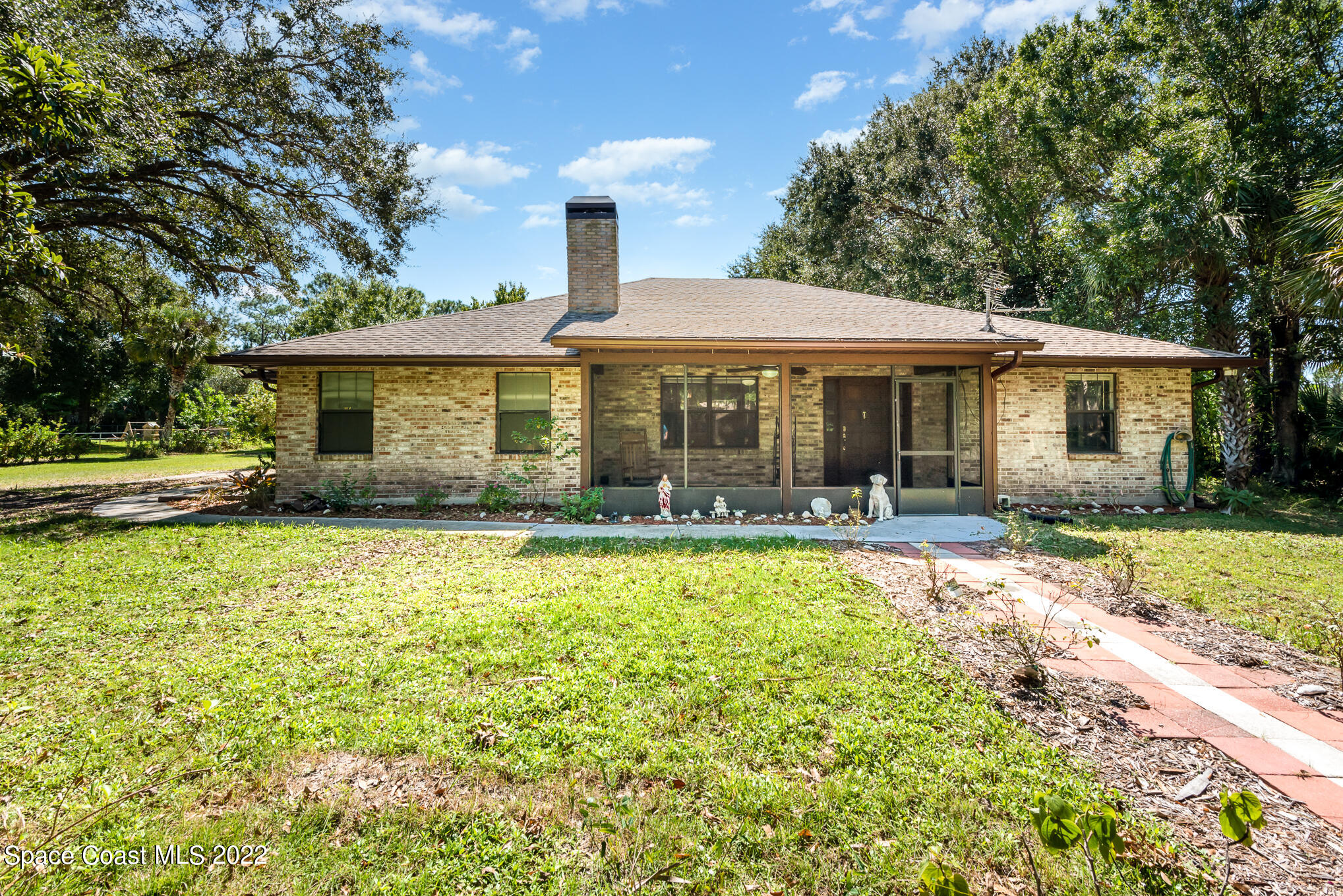 4275 Rayburn Road Cocoa, FL 32926 - Photo 1 of 26 a front view of a house with garden