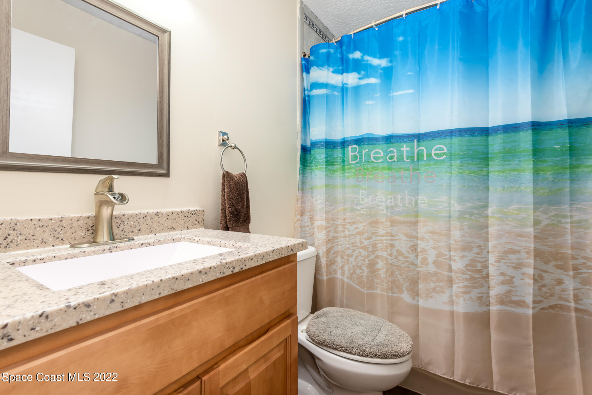 4275 Rayburn Road Cocoa, FL 32926 - Photo 11 of 26 a bathroom with a sink a toilet and shower
