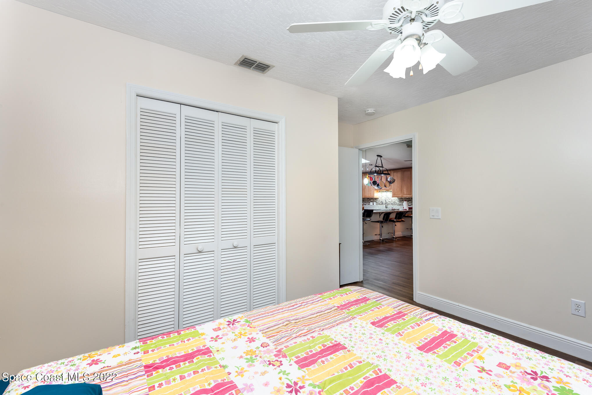 4275 Rayburn Road Cocoa, FL 32926 - Photo 13 of 26 a bedroom with a bed and a chandelier