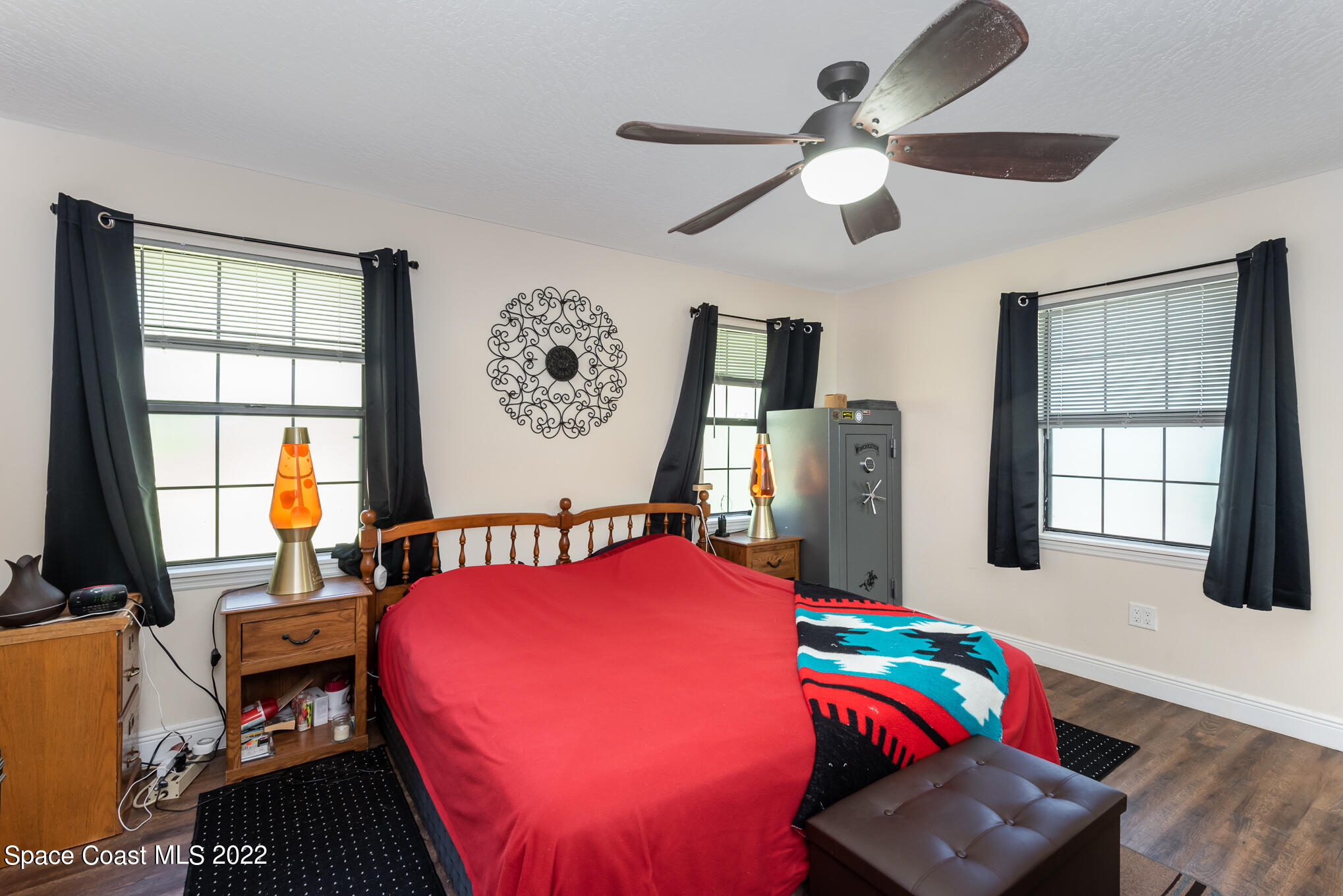 4275 Rayburn Road Cocoa, FL 32926 - Photo 14 of 26 a bedroom with a bed bookshelf and a large window