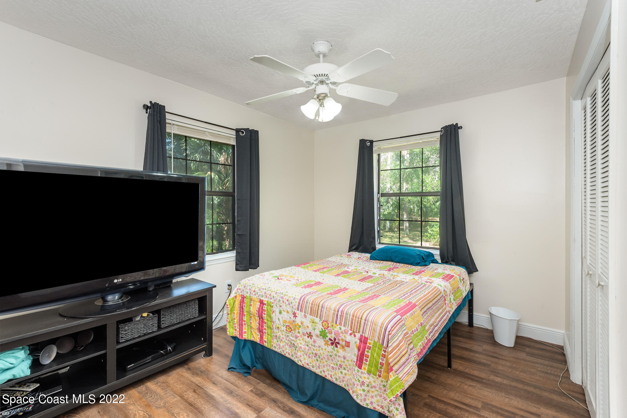4275 Rayburn Road Cocoa, FL 32926 - Photo 15 of 26 a bedroom with a bed and a flat screen tv