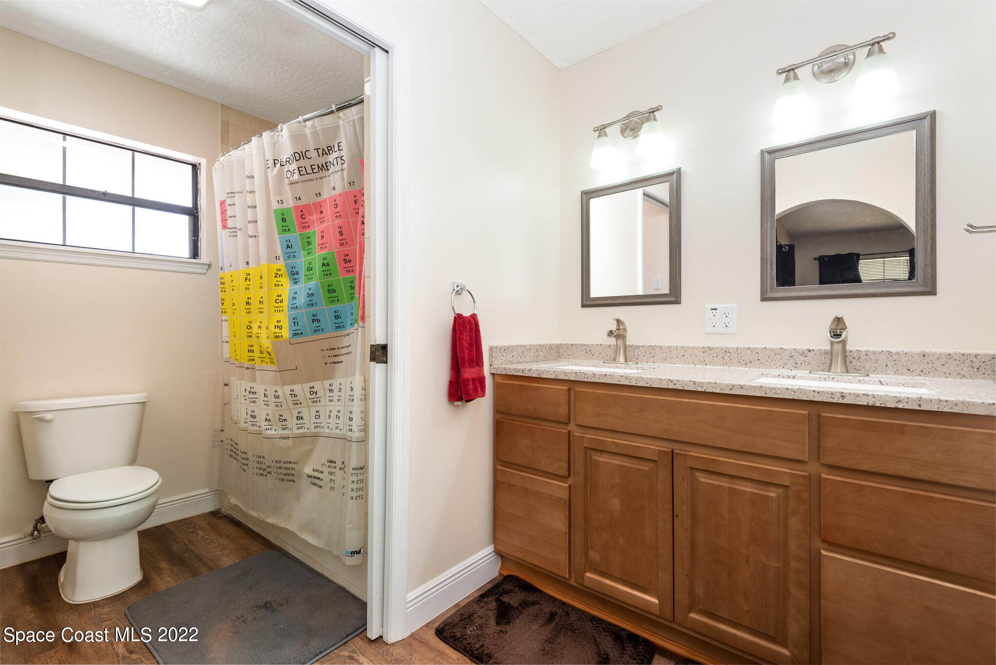 4275 Rayburn Road Cocoa, FL 32926 - Photo 16 of 26 a bathroom with a toilet sink and mirror