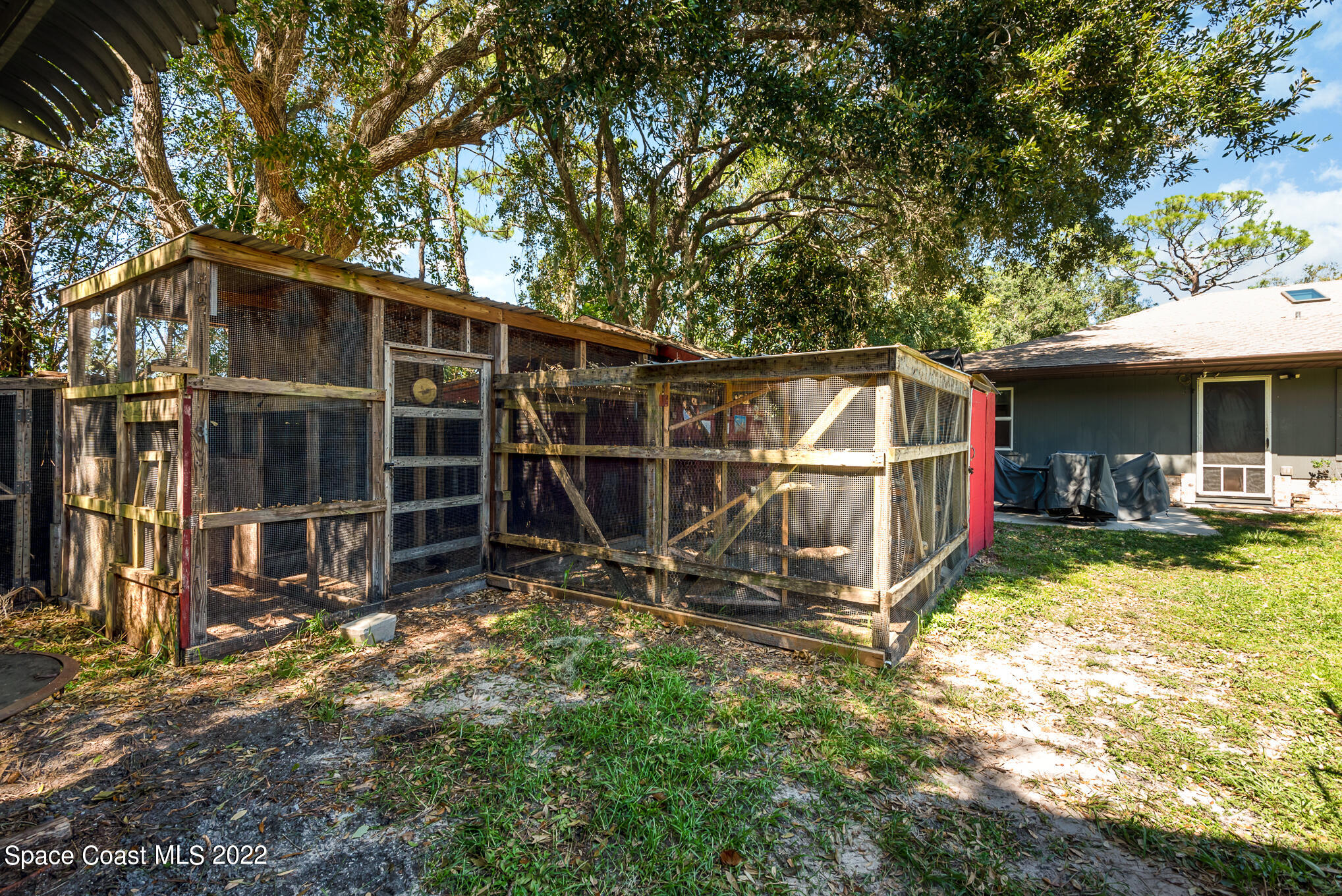 4275 Rayburn Road Cocoa, FL 32926 - Photo 25 of 26 a view of a backyard with wooden fence and a large tree