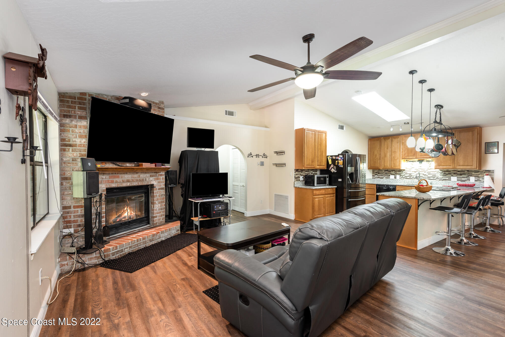 4275 Rayburn Road Cocoa, FL 32926 - Photo 3 of 26 a living room with furniture a fireplace and a flat screen tv