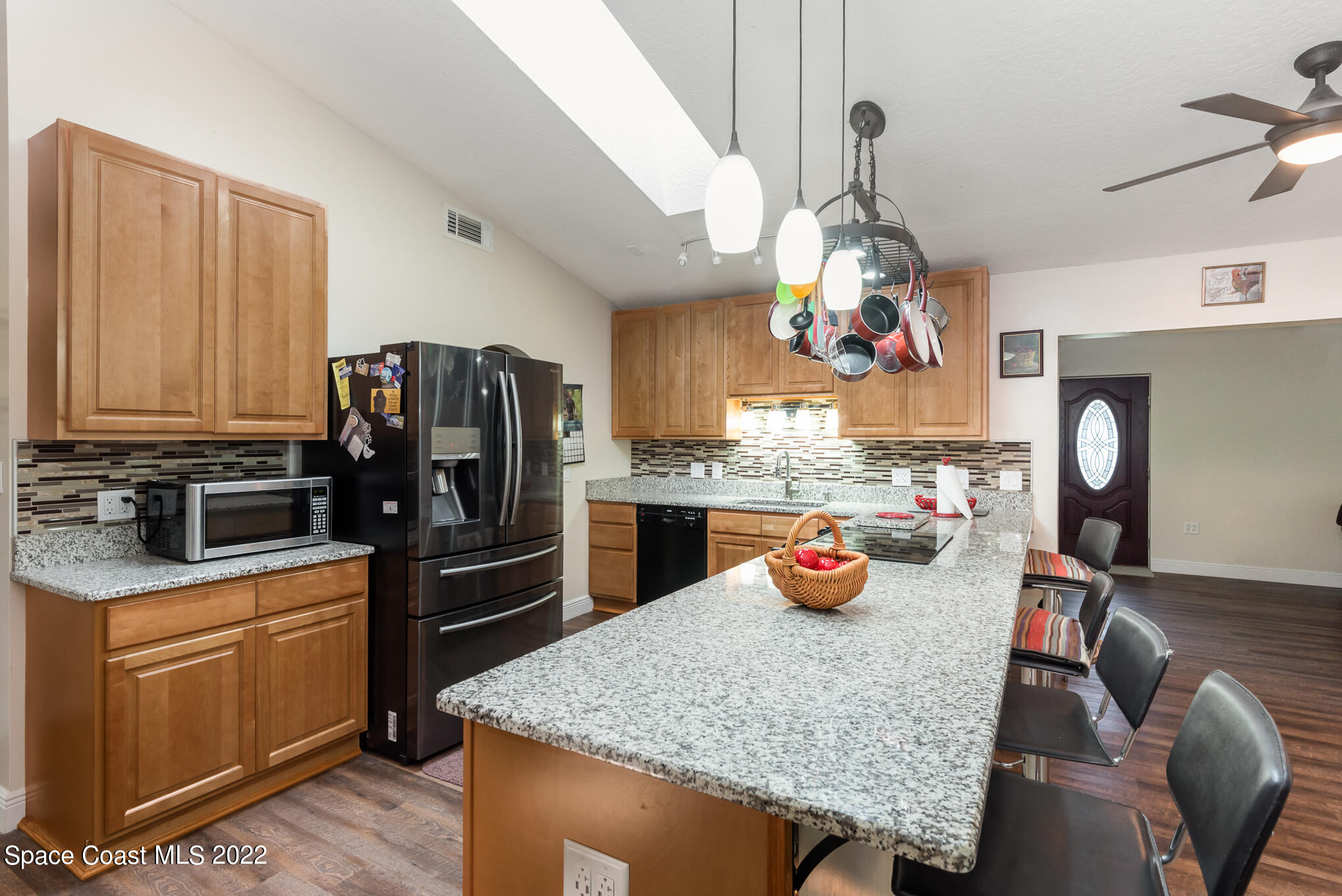 4275 Rayburn Road Cocoa, FL 32926 - Photo 4 of 26 a kitchen with stainless steel appliances granite countertop a sink refrigerator and microwave