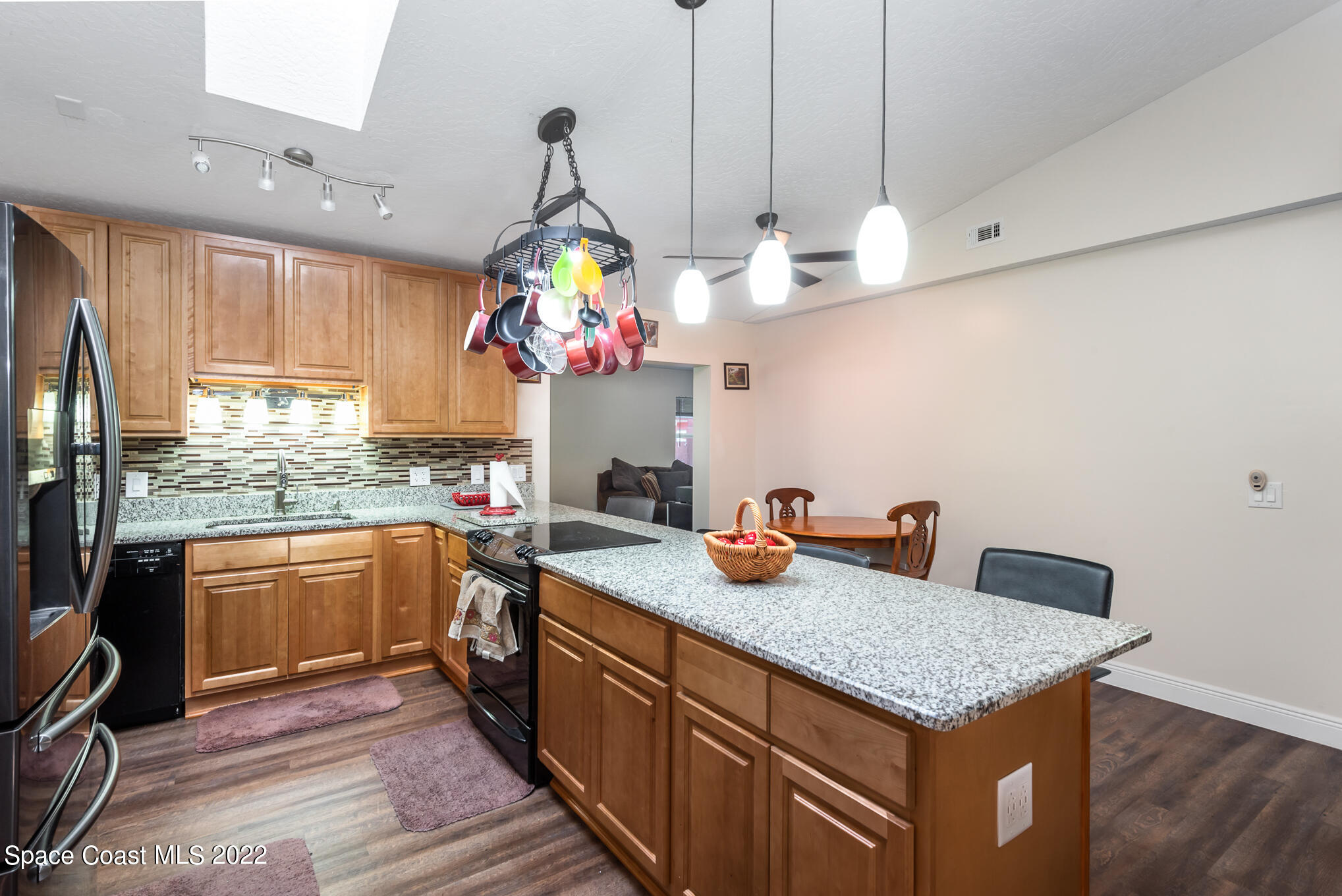 4275 Rayburn Road Cocoa, FL 32926 - Photo 5 of 26 a kitchen with granite countertop a sink cabinets and wooden floor