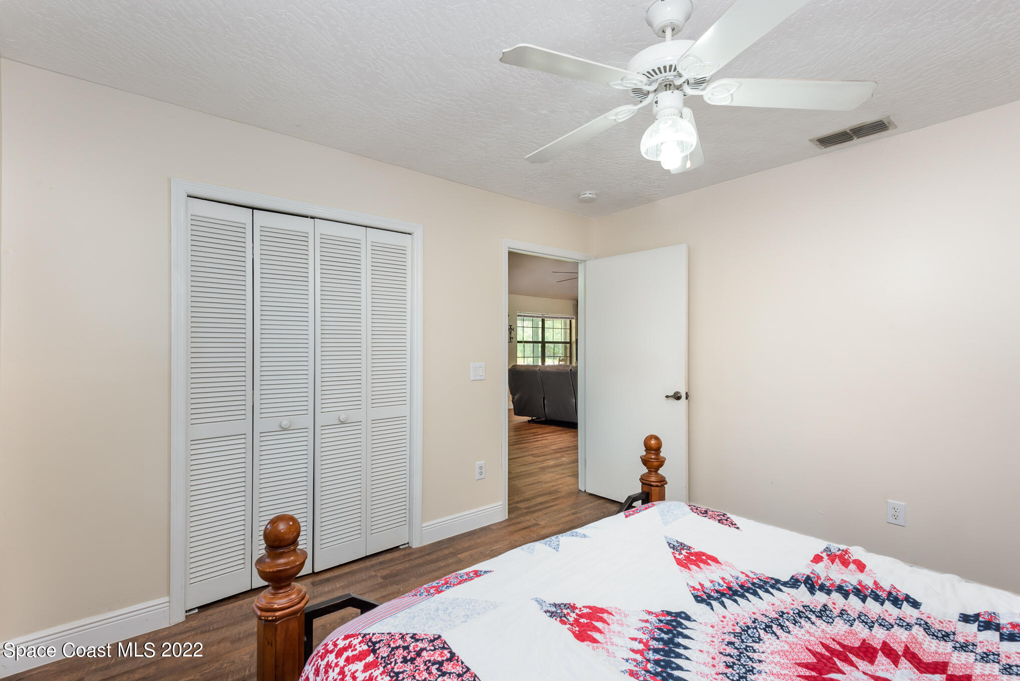 4275 Rayburn Road Cocoa, FL 32926 - Photo 10 of 26 a bedroom with a bed and a chandelier